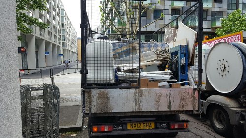 Volunteers collecting reusable furniture from a skip for charity